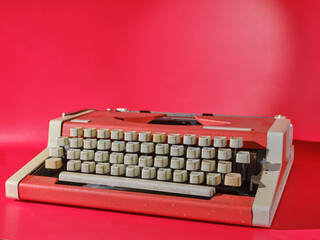 Red typewriter on red background