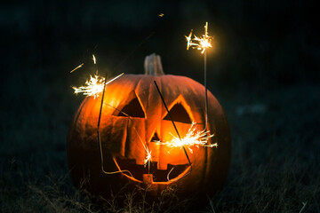 Carved Halloween pumpkin with sparkler