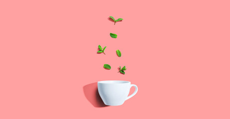 Fresh mints with tea cup overhead view - flat lay