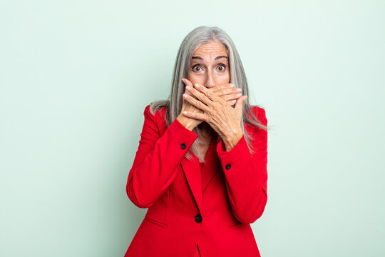 middle age gray hair woman covering mouth with hands with a shocked. senior businesswoman concept