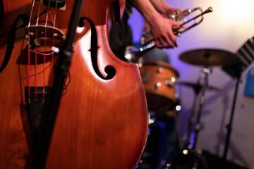 A good looking acoustic double bass captured from a live performance gig in a bar with a trumpet...