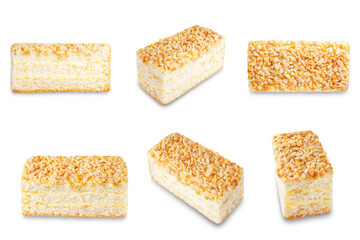 Sponge cake with cream and nuts on a white isolated background