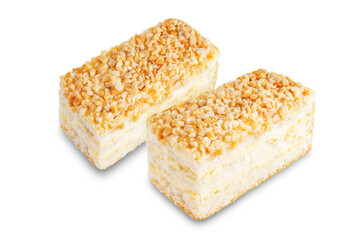 Sponge cake with cream and nuts on a white isolated background