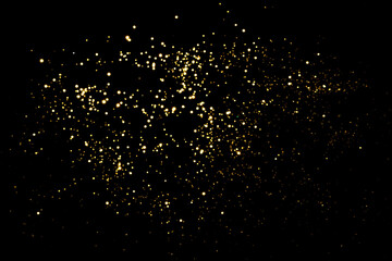 Golden blurred bokeh lights on black background. Glitter sparkle stars for celebrate. Overlay for...