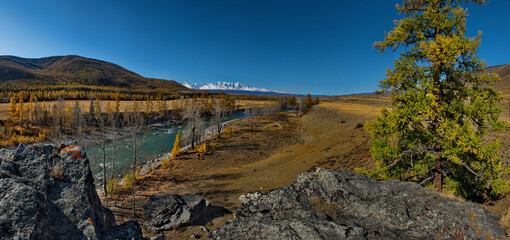 Russia. The South of Western Siberia, the Altai Mountains. Autumn on the Chuya River at the foot of the North Chuya Mountain range along the Chuya tract.