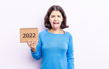 pretty young woman feeling disgusted and irritated and tongue out. 2022 calendar concept