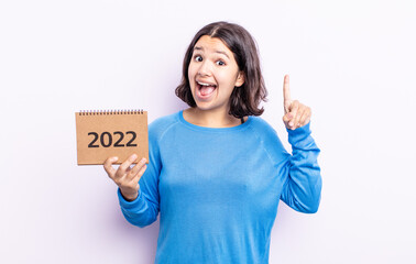 pretty young woman feeling like a happy and excited genius after realizing an idea. 2022 calendar...