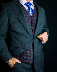 Portrait of Gentleman in Gray Suit Standing Elegantly on Black Background. Vintage Style and Retro Fashion.