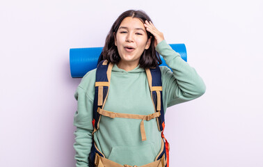 pretty young woman looking happy, astonished and surprised. hiking concept