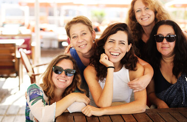Women best friends sitting in summer cafe on the beach - 465332849
