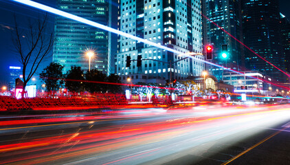 moving car with blur light through modern city at night.
