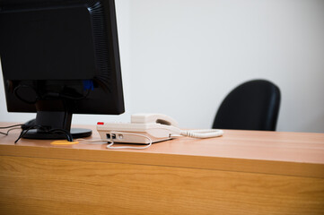 computer and telephone on a desk in a modern office