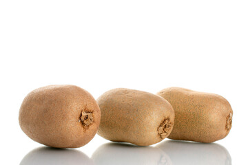 Three juicy organic kiwi fruits, close-up, isolated on white.