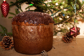 Italian Christmas Easter on the background of a decorated Christmas tree. Chocolate Panettone. 