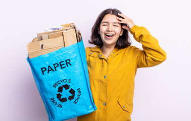 pretty young woman looking happy, astonished and surprised. paper recycle concept