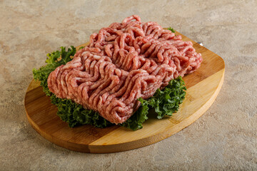 Raw pork minced meat over board