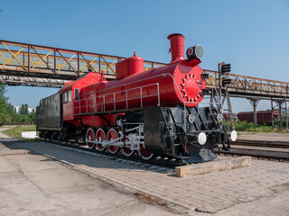 Old steam locomotive at the railway station. Close-up.