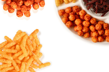 Mix of snacks on a white plate isolated on white.