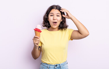 pretty young woman looking happy, astonished and surprised. ice cream concept