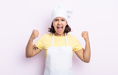 pretty young woman shouting aggressively with an angry expression. chef concept