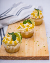 lime cupcakes on a wooden table with a cloth