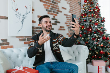 The man himself celebrates Christmas at home, receives greetings from friends communicates by video using the application on the phone