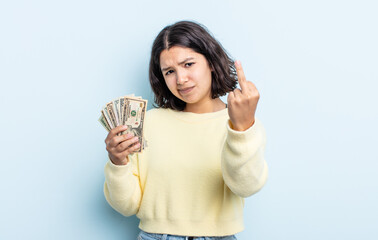 pretty young woman feeling angry, annoyed, rebellious and aggressive. dollar banknotes concept