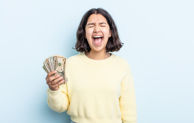 pretty young woman shouting aggressively, looking very angry. dollar banknotes concept