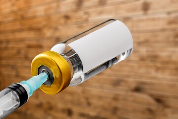 nurse draws a Covid-19 vaccine dose into a syringe with vaccine