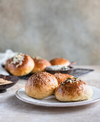 Sweet pumpkin buns with cinnamon and anise, light concrete background.