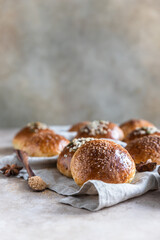 Sweet pumpkin buns with cinnamon and anise, light concrete background.