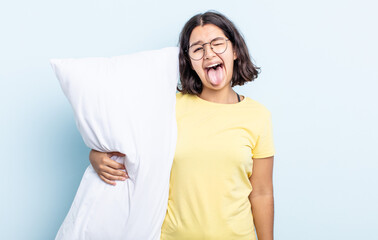 pretty young woman with cheerful and rebellious attitude, joking and sticking tongue out. bed...