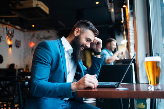 A businessman using his laptop in a pub