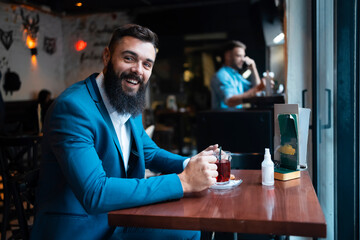 A businessman drinking his morning tea in a bar