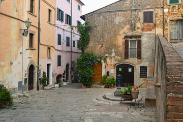 Glimpse of the medieval village in the Tuscan Maremma area with ancient buildings in summer, Castagneto Carducci, Livorno, Tuscany, Italy