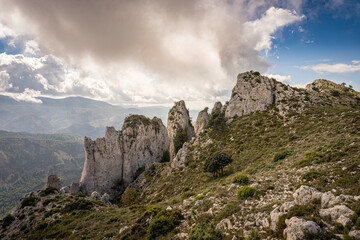 Fototapeta na wymiar Landscape with steep mountains on a day with sun and clouds, in Serrella mountain, Alicante (Spain)