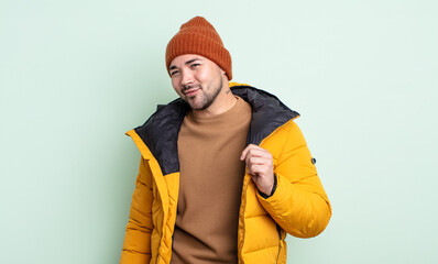 young handsome man looking arrogant, successful, positive and proud. cold weather concept