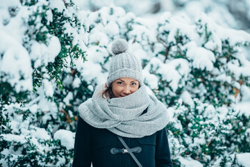 Beautiful young woman wearing scarf and a a hat on a cold winter day