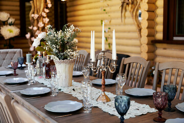 Table setting for a family dinner in a restaurant with candles