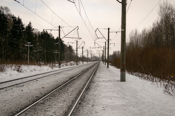 Railroad track stretching into the winter distance. Transport concept.