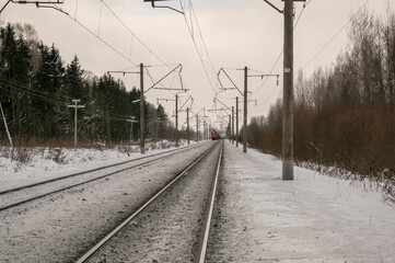 Railroad track stretching into the winter distance. Transport concept.