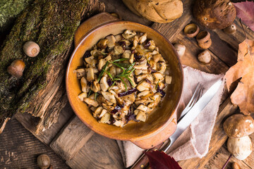 Fried forest mushrooms, boletus, onions. Rustic dish in a frying pan, vegetarian autumn food on top of view