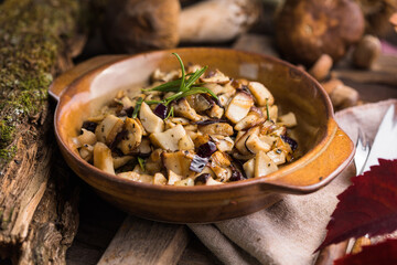 Fried forest mushrooms, boletus, onions. Rustic dish in a frying pan, vegetarian autumn food on top of view