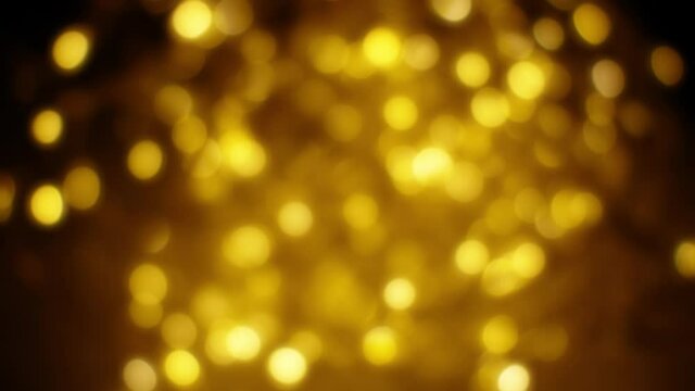 Beautiful blurred flickering yellow light on the party. Home decoration with garlands on the window, night Bokeh lighting. Festive new year background.