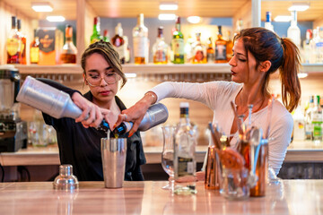 Bartender women preparing a cocktail in a pub