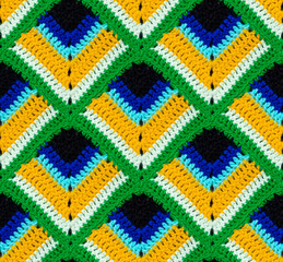 Seamless knitted texture. The pattern in the form of a peacock feather is crocheted with...