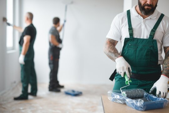 Builder Preparing To Paint The Apartment During Renovation