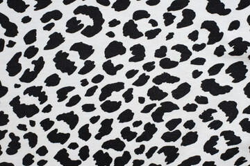 Black spots on a white background - texture print on the fabric of a dalmatian dog