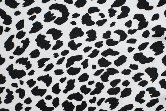 Black spots on a white background - texture print on the fabric of a dalmatian dog