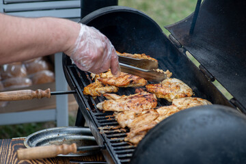 Chef grill barbecue meat and ribs outdoors. BBQ meat
